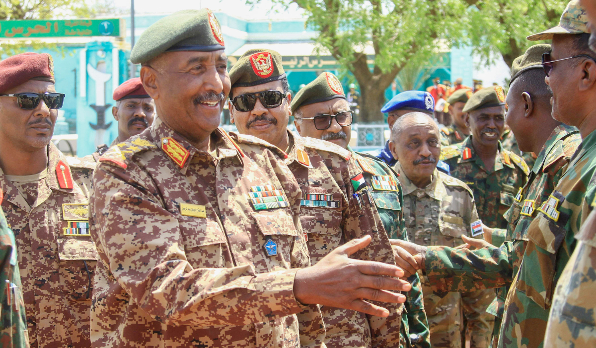 War-torn Sudan's army chief Abdel Fattah al-Burhan greets military personnel as he visits casualties receiving treatment at a hospital in the southeastern Gedaref state, on the first day of Eid al-Fitr that marks the end of the Islamic fasting month of Ramadan on April 10, 2024. (AFP)