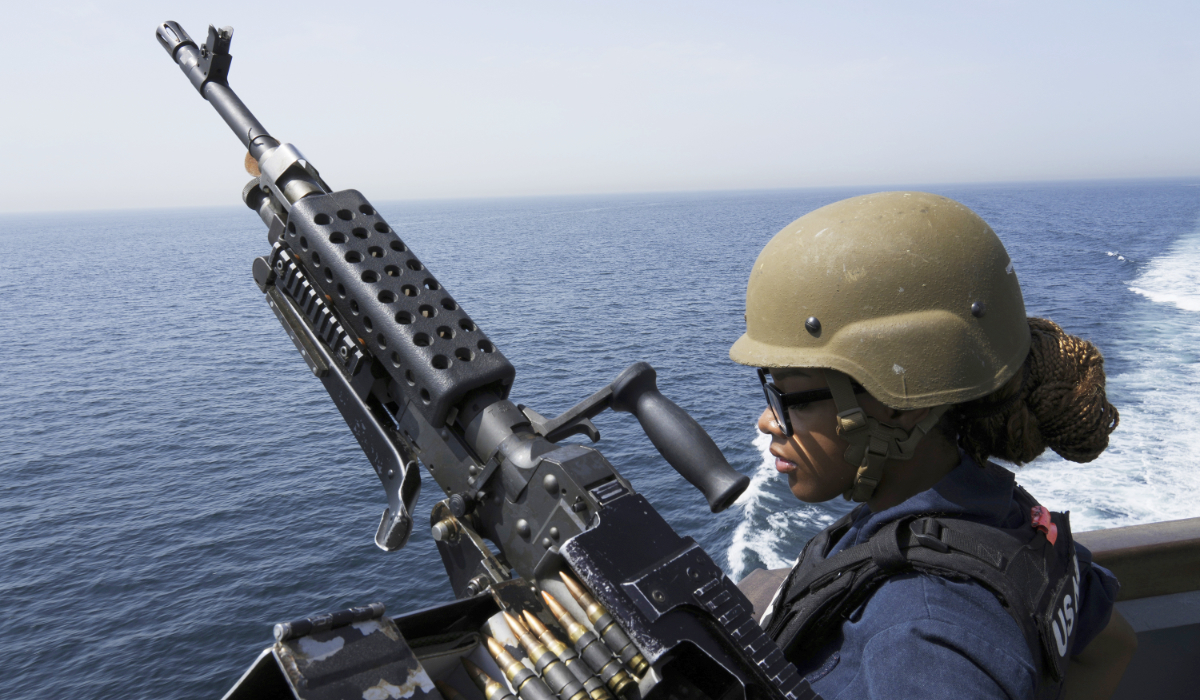 US Navy retail service specialist stands guard next to a machine gun aboard the USS Paul Hamilton in the Strait of Hormuz Friday. (AP file photo)