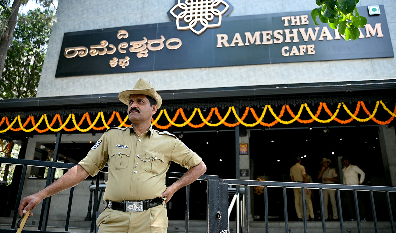 A police personnel stands guard near the site of a bomb blast at Rameshwaram Cafe in Bengaluru on March 2, 2024. (AFP/File)