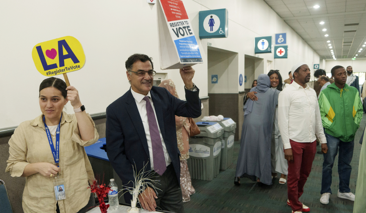 President and co-founder of the Muslim Public Affairs Council, Salam Al-Marayati, second from left, invites American Muslims citizens to register to vote after thousands gathered to mark the end of the holy month of Ramadan in Los Angeles Wednesday, April 10, 2024. (AP)