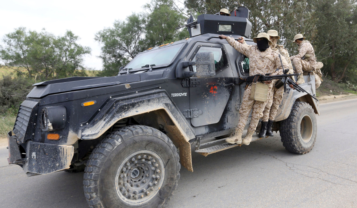 Members of the Tripoli Protection Force, an alliance of militias from the capital city, patrol an area south of the Libyan capital on January 18, 2019, during clashes with the Seventh Brigade group from the town of Tarhuna. (AFP)