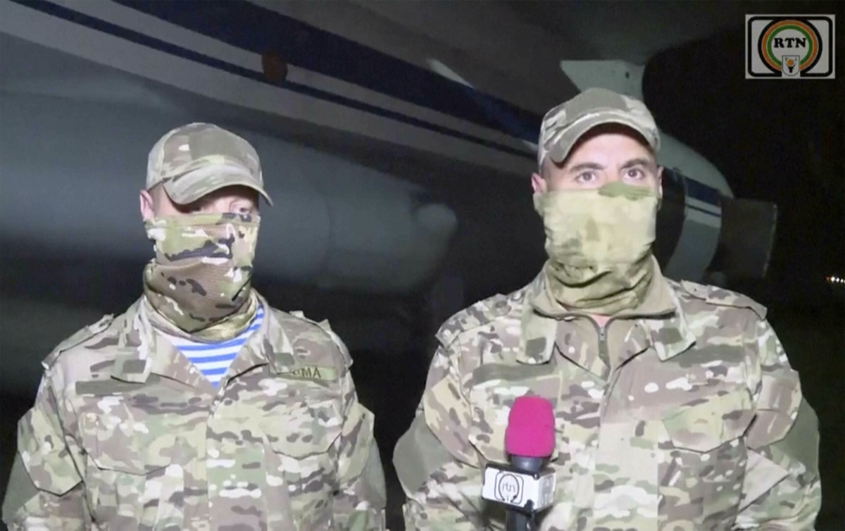 In this image taken from video from RTN, Russian military instructors speak to media on their arrival in Niamey, Niger, on April 10, 2024. (RTN via AP)