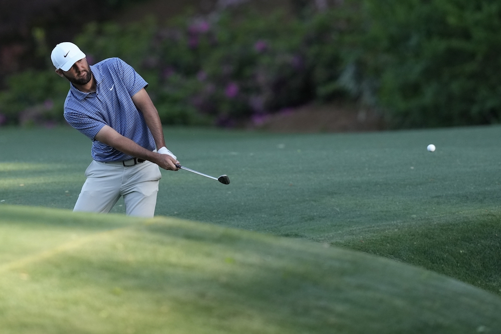 Scottie Scheffler chips to the green on the 13th hole during second round at the Masters golf tournament at Augusta National Golf Club Friday in Augusta, Georgia. (AP)