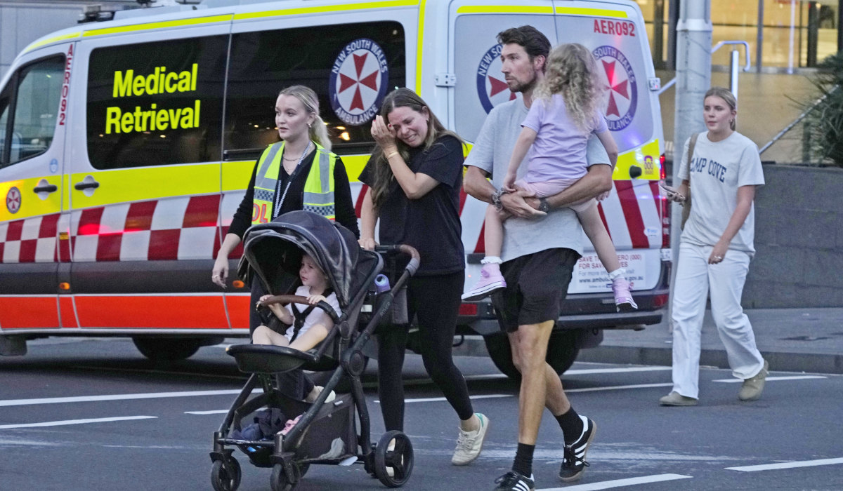 People are led out from the Westfield Shopping Centre where multiple people were stabbed in Sydney, Saturday, April 13, 2024. (AP)
