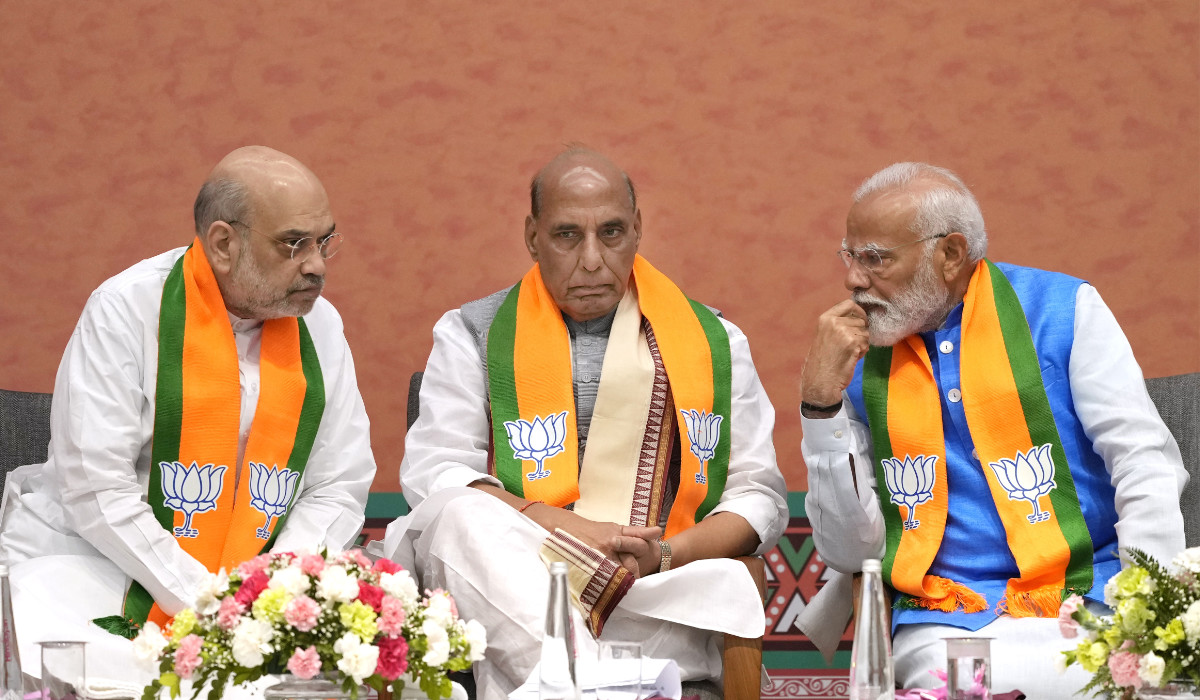 Indian prime Minister Narendra Modi, right, talks to Bharatiya Janata Party (BJP) senior leaders and his cabinet colleagues Home Minister Amit Shah, left, and Defence Minister Rajnath Singh during an event organized to release their party's manifesto for the upcoming national parliamentary elections in New Delhi, India, Sunday, April 14, 2024. (AP)