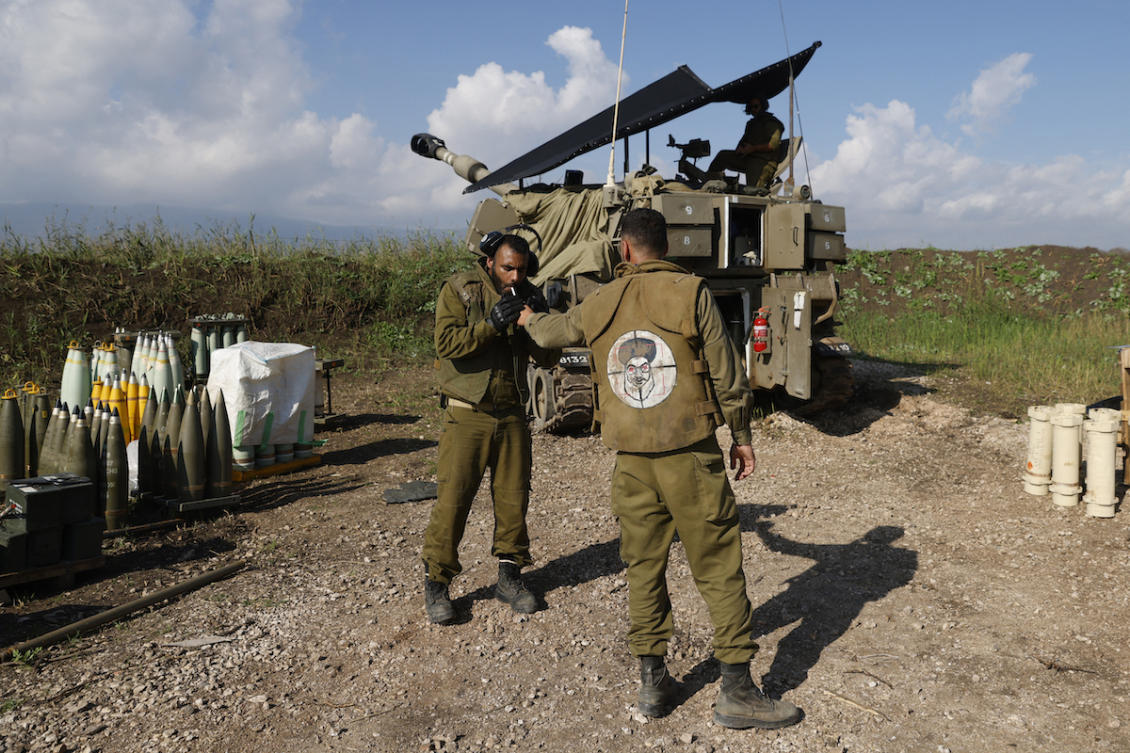 An Israeli soldier wearing a patch on the back of his flack jacket showing Lebanon's Hezbollah leader Hassan Nasrallah as a target. (File/AFP)