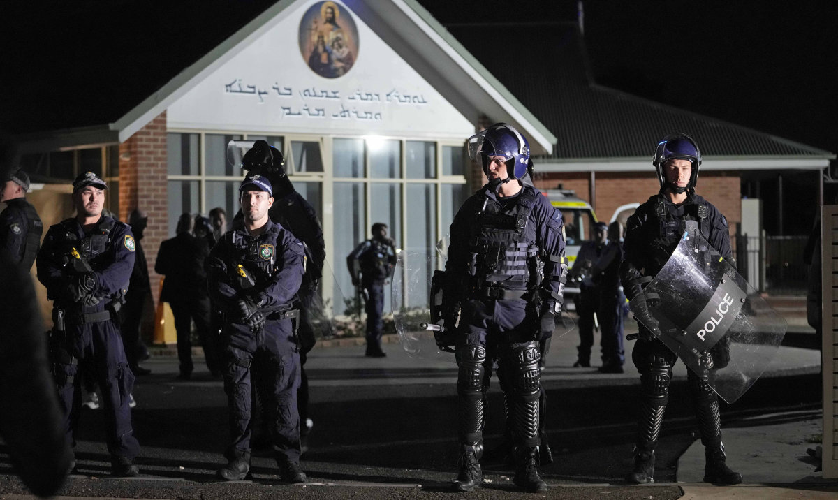 Security officers stand guard outside Orthodox Assyrian church in Sydney, Australia, Monday, April 15, 2024. (AP)
