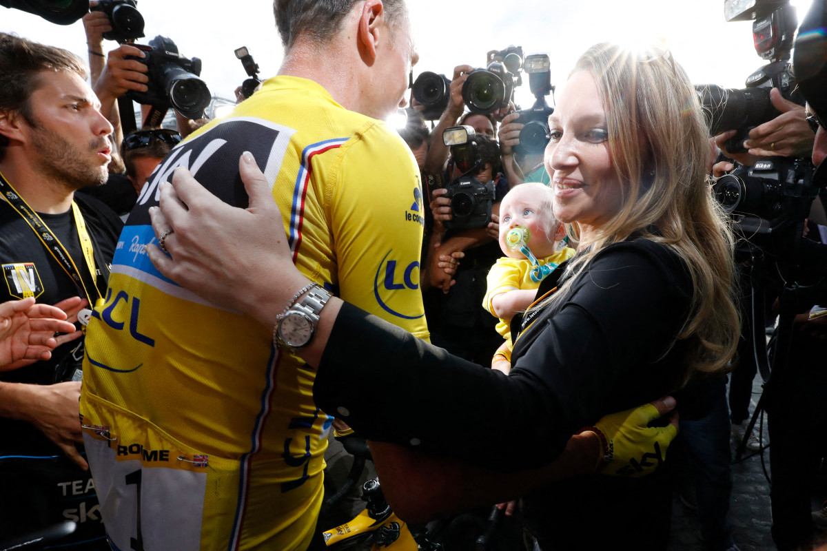Tour de France 2016's winner Great Britain's Christopher Froome (L) wearing the overall leader's yellow jersey, celebrates with his wife Michelle (R). (File/AFP)