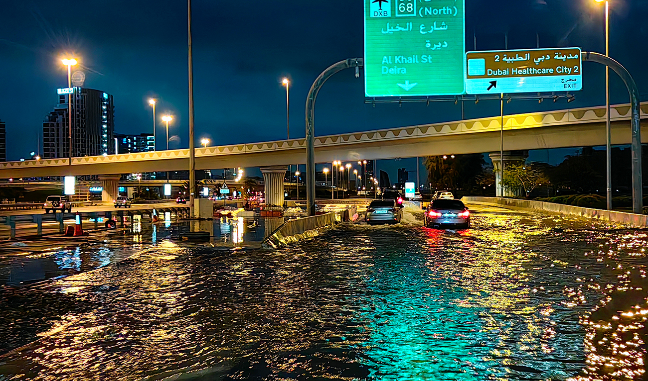 Motorisits drive along a flooded street following heavy rains in Dubai early on April 17, 2024. (AFP)