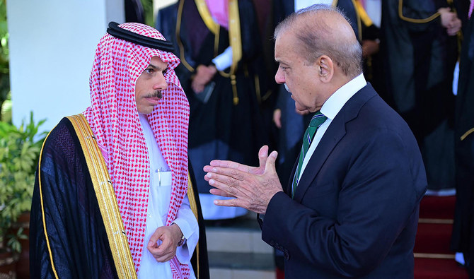 This handout photograph taken on April 16, 2024 and released by Pakistan's Press Information Department (PID) shows Pakistan's Prime Minister Shehbaz Sharif (R) speaking with Saudi Arabia's Foreign Minister Faisal bin Farhan upon his arrival at the Prime Minister House in Islamabad. (PID)