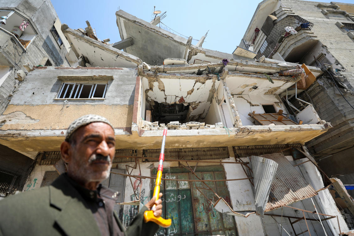 Palestinian man Ali Oroq, whose grandson Zein was wounded after he was hit by aid airdropped on Gaza and later succumbed to his wounds, points with a cane to their house which was hit in an Israeli strike, amid the ongoing conflict between Israel and the Palestinian Islamist group Hamas, in Gaza City (REUTERS)