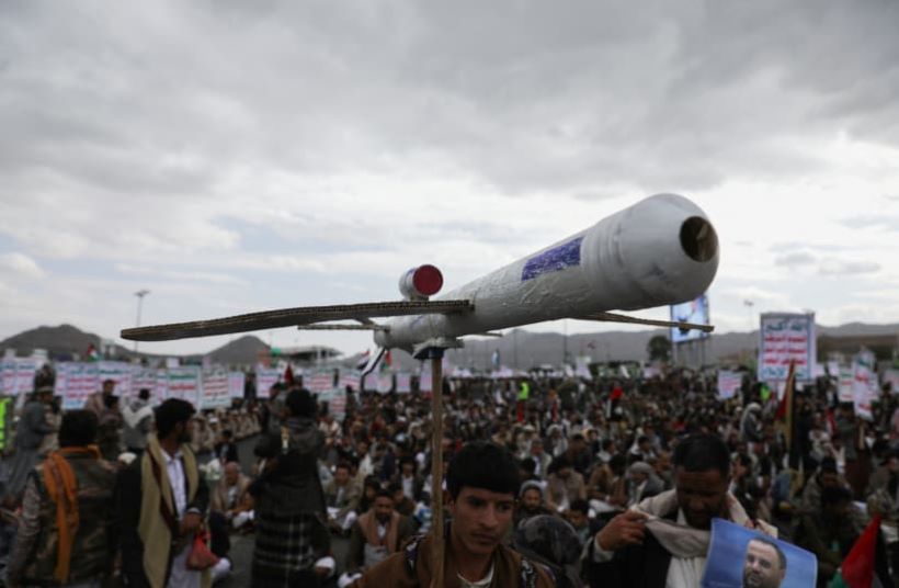 A Houthi supporter carries a mock drone, Sanaa, Yemen, Feb. 16, 2024. (Reuters)