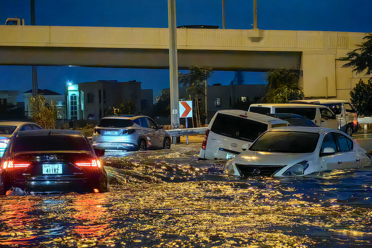 Cars drive in a flooded street following heavy rains in Dubai on April 17, 2024. (File/AFP)