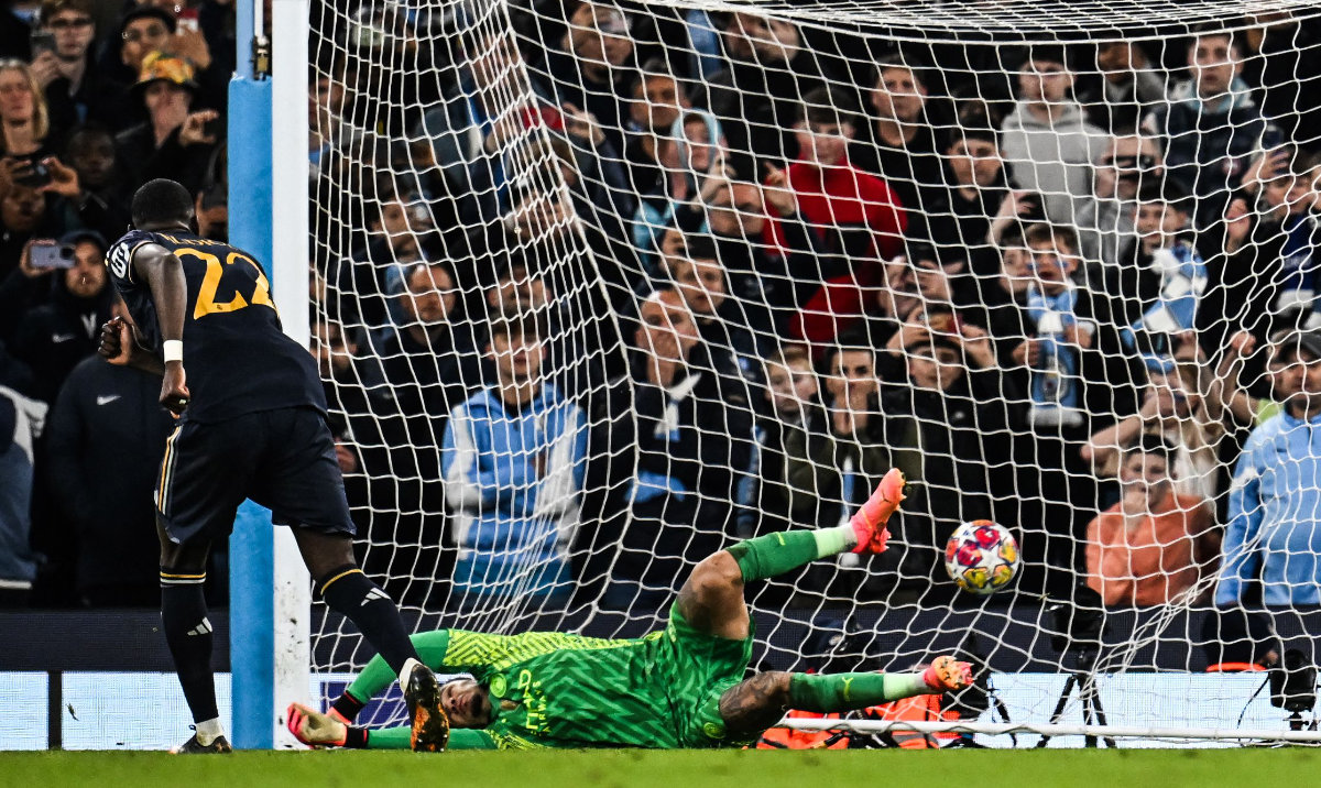 Real Madrid's German defender Antonio Rudiger (L) scores the winning penalty past Manchester City's Brazilian goalkeeper Ederson during the penalty shootout at the UEFA Champions League quarterfinal second leg between Manchester City and Real Madrid at the Etihad Stadium. (AFP)