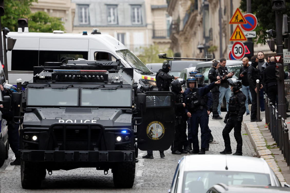 French police and members of French special police forces of Research and Intervention Brigade secure the area near Iran consulate where a man is threatening to blow himself up, in Paris on April 19, 2024. (Reuters)