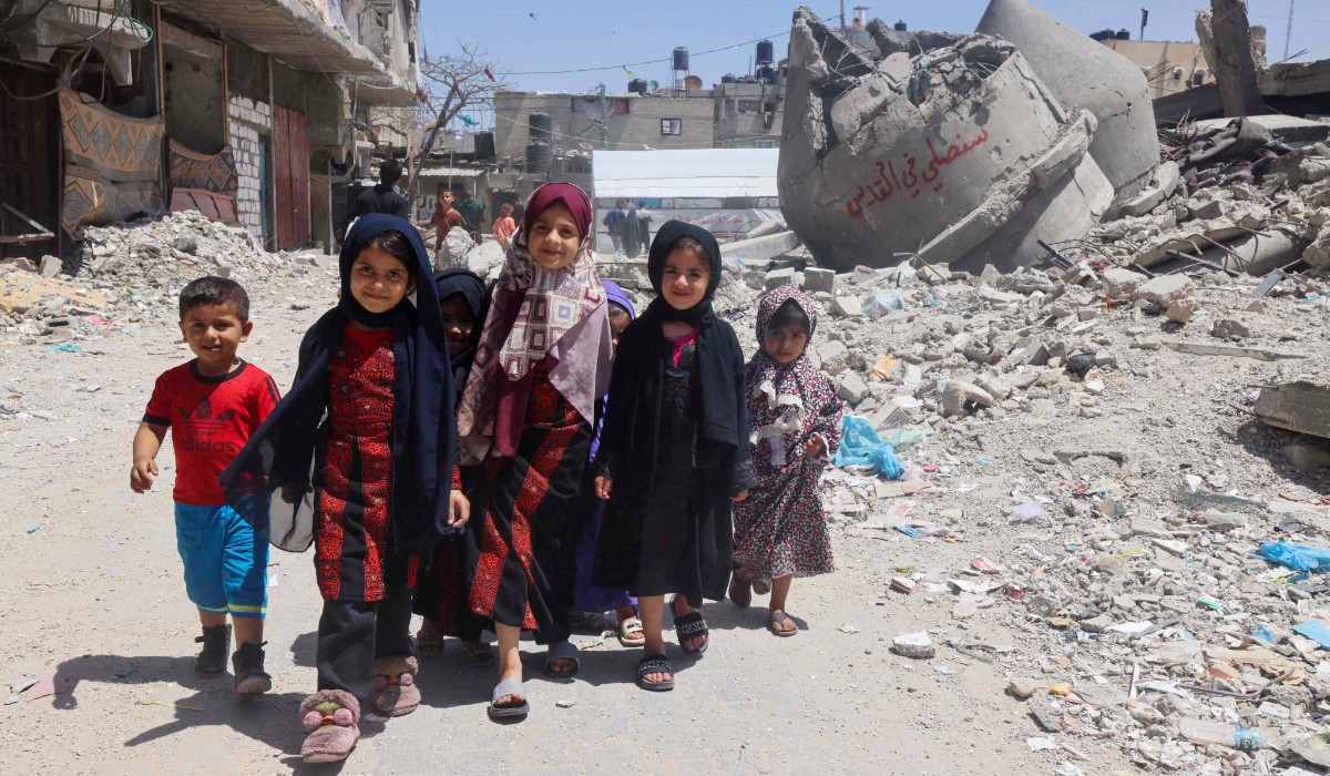 Palestinian children walk next to the ruins of Al-Farouq Mosque in Rafah in the southern Gaza Strip on Friday amid ongoing battles between Israel and Hamas. AFP The mosque was destroyed during Israeli bombardment. (AFP)