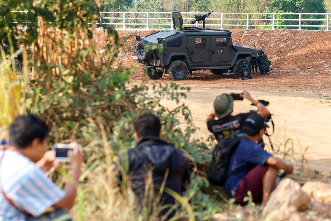 Thai soldiers and members of the media take cover during fighting on the Myanmar side between the Karen National Liberation Army and Myanmar’s troops, which continues near the Thailand-Myanmar border on April 20, 2024. (Reuters)