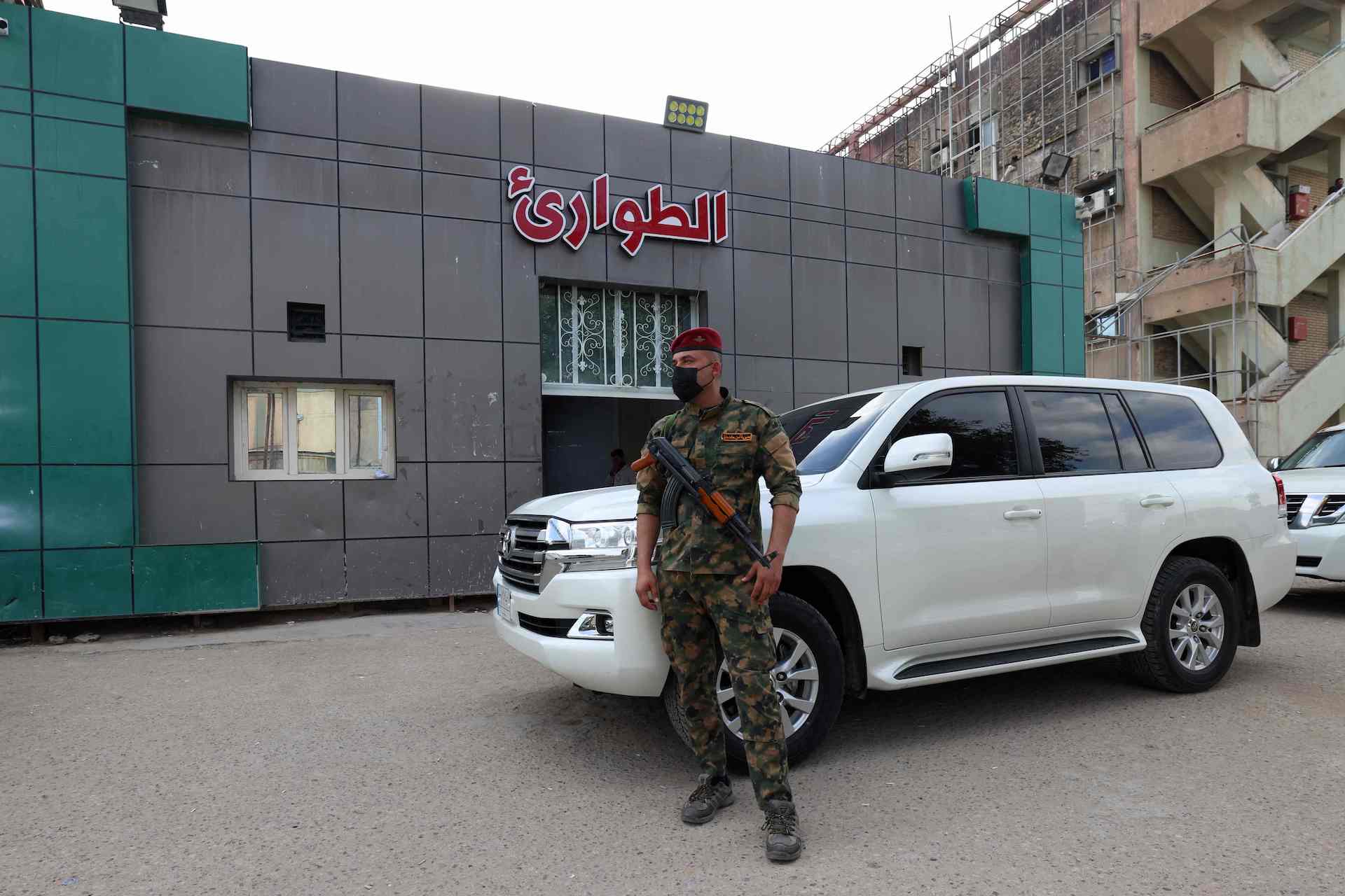 A soldier stands guard at the entrance of the emergency ward of a hospital in Hilla in the central Iraqi province of Babylon where people wounded in an explosion overnight on an Iraqi military base housing a coalition of pro-Iranian armed groups are being treated, on April 20, 2024. (AFP)