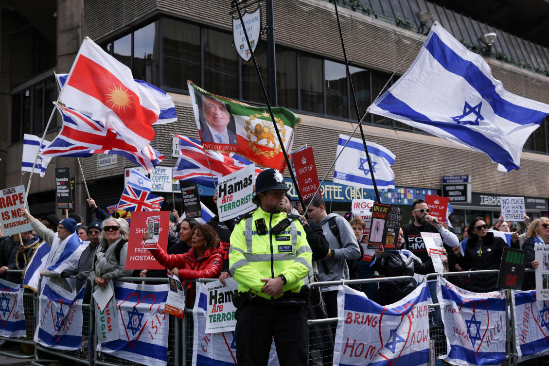 A police officer stands guard as protesters attend a pro-Israeli counter-demonstration near Barclays Bank, in London on Apr. 20, 2024. (Reuters)