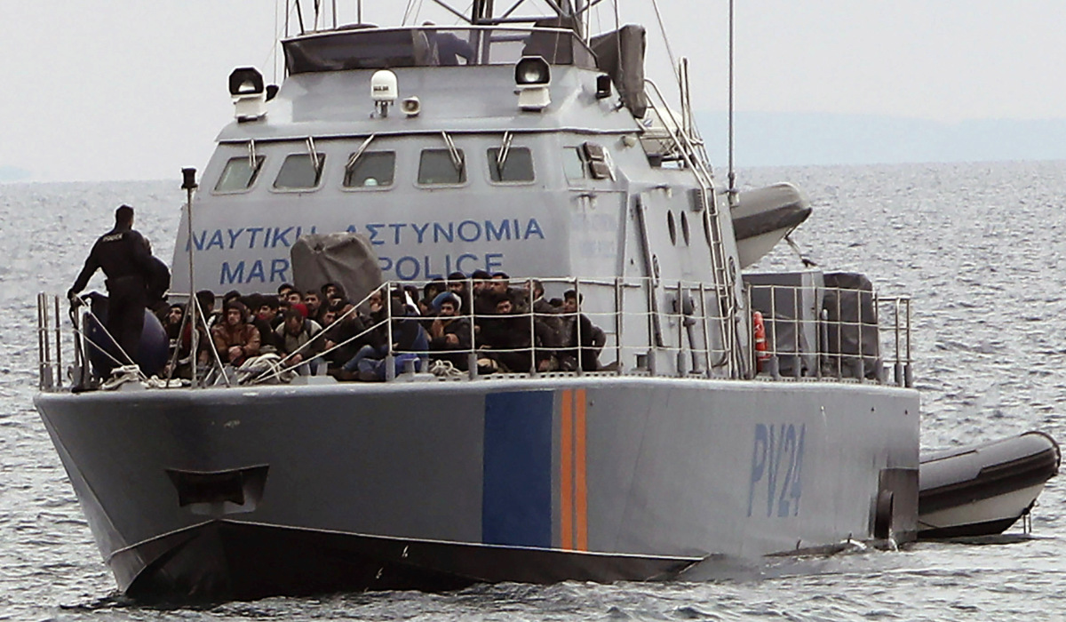 Migrants aboard a Cyprus marine police patrol boat as they're brought to a harbor after being rescued from their own vessel off the Mediterranean island nation's southeastern coast of Protaras, Cyprus, Tuesday, Jan. 14, 2020. (AP)