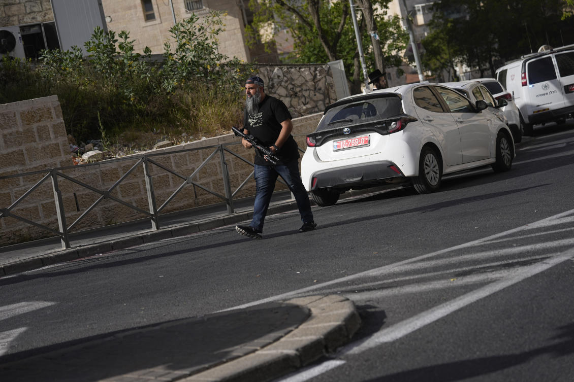 A plainclothes Israeli police officer works at the scene of a suspected ramming attack that wounded three people on the eve of the Jewish holiday of Passover, in Jerusalem, Monday, April 22, 2024. (AP)