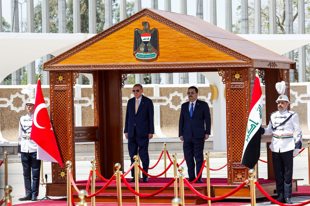 Iraqi Prime Minister Mohammed Shia Al-Sudani, right, and Turkish President Tayyip Erdogan attend a welcoming ceremony at Baghdad International Airport, in Baghdad on April 22, 2024. (Reuters)