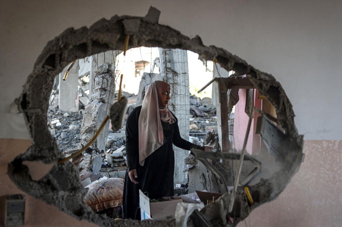 A Palestinian woman checks the rubble of a home hit by overnight Israeli bombing in Rafah in the southern Gaza Strip amid the ongoing conflict between Israel and the Hamas movement. (File/AFP)