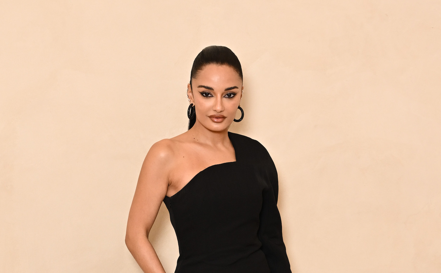 Amina Muaddi shared a teaser with her Instagram followers featuring a model opening a cream-colored clutch. (Getty Images)