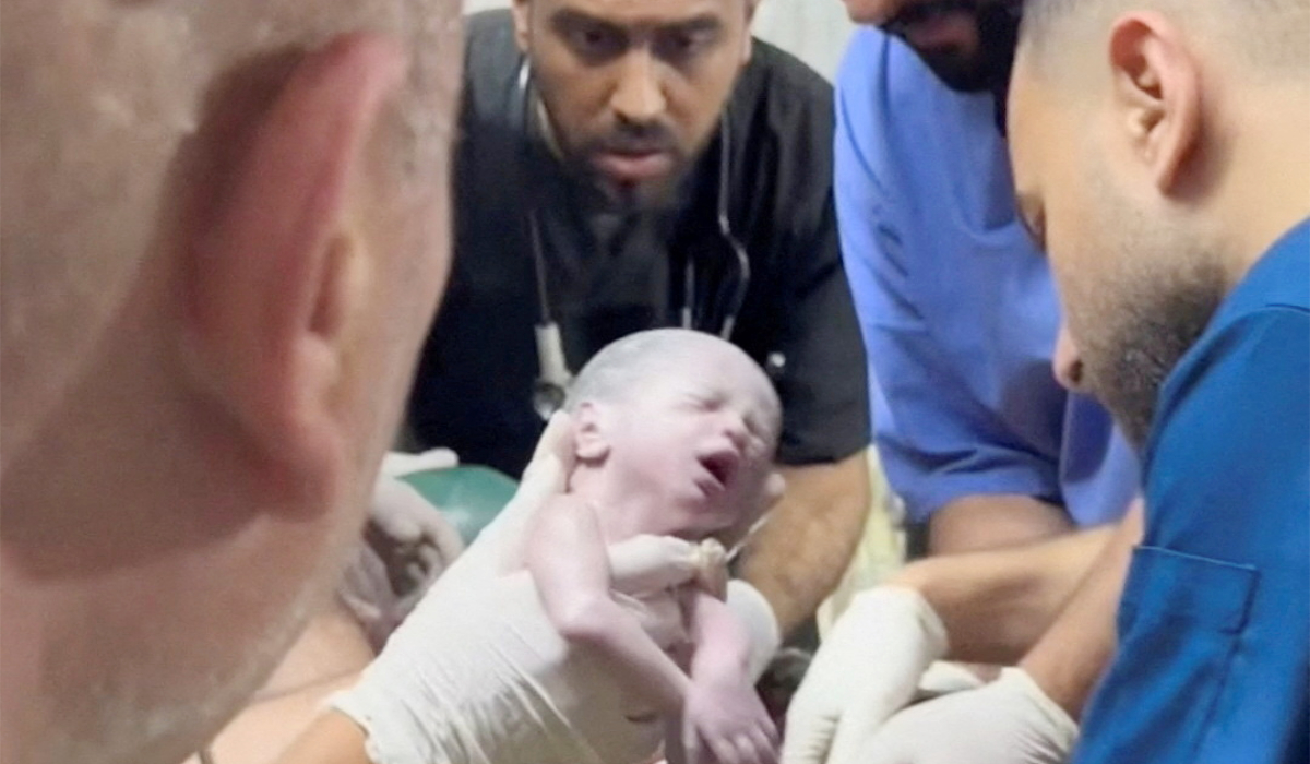 A medic holds a Palestinian newborn girl after she was pulled alive from the womb of her mother Sabreen Al-Sheikh (Al-Sakani), who was killed in an Israeli strike, along with her husband Shokri and her daughter Malak in the southern Gaza Strip. (REUTERS)