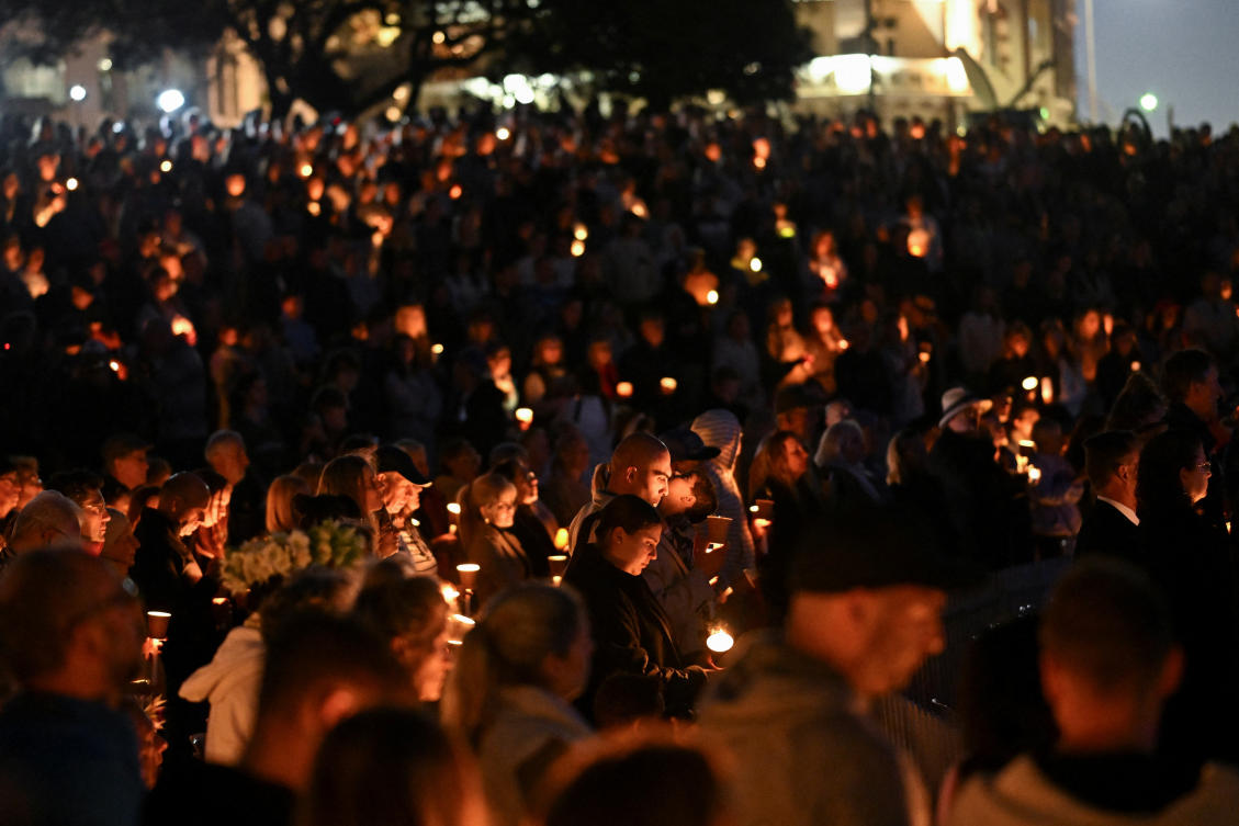 People hold candles during the Community Candlelight Vigil, recognising the victims of a fatal stabbing attack at Bondi Junction Westfield shopping centre, in Sydney. (File/Reuters)