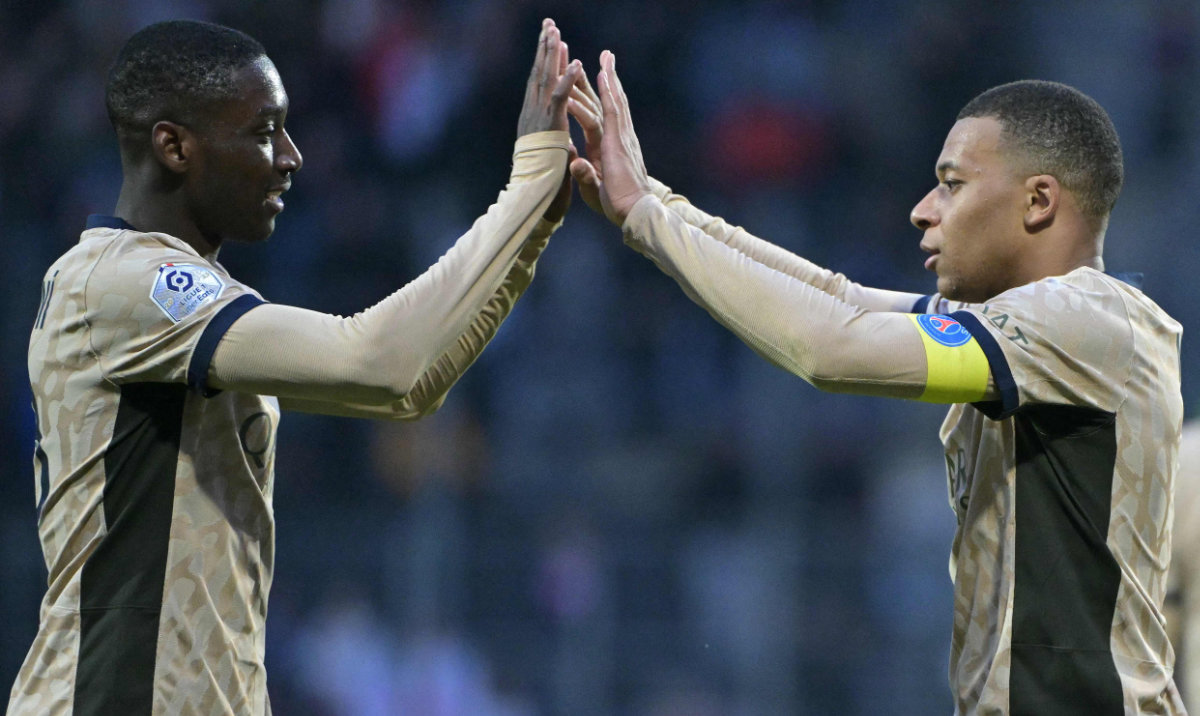 Paris Saint-Germain's French forward Kylian Mbappe (R) and teammate French forward Randal Kolo Muani high five each other as they celebrate their victory at the end of their French L1 match against FC Lorient at the Stade du Moustoir in Lorient on April 24, 2024. (AFP)