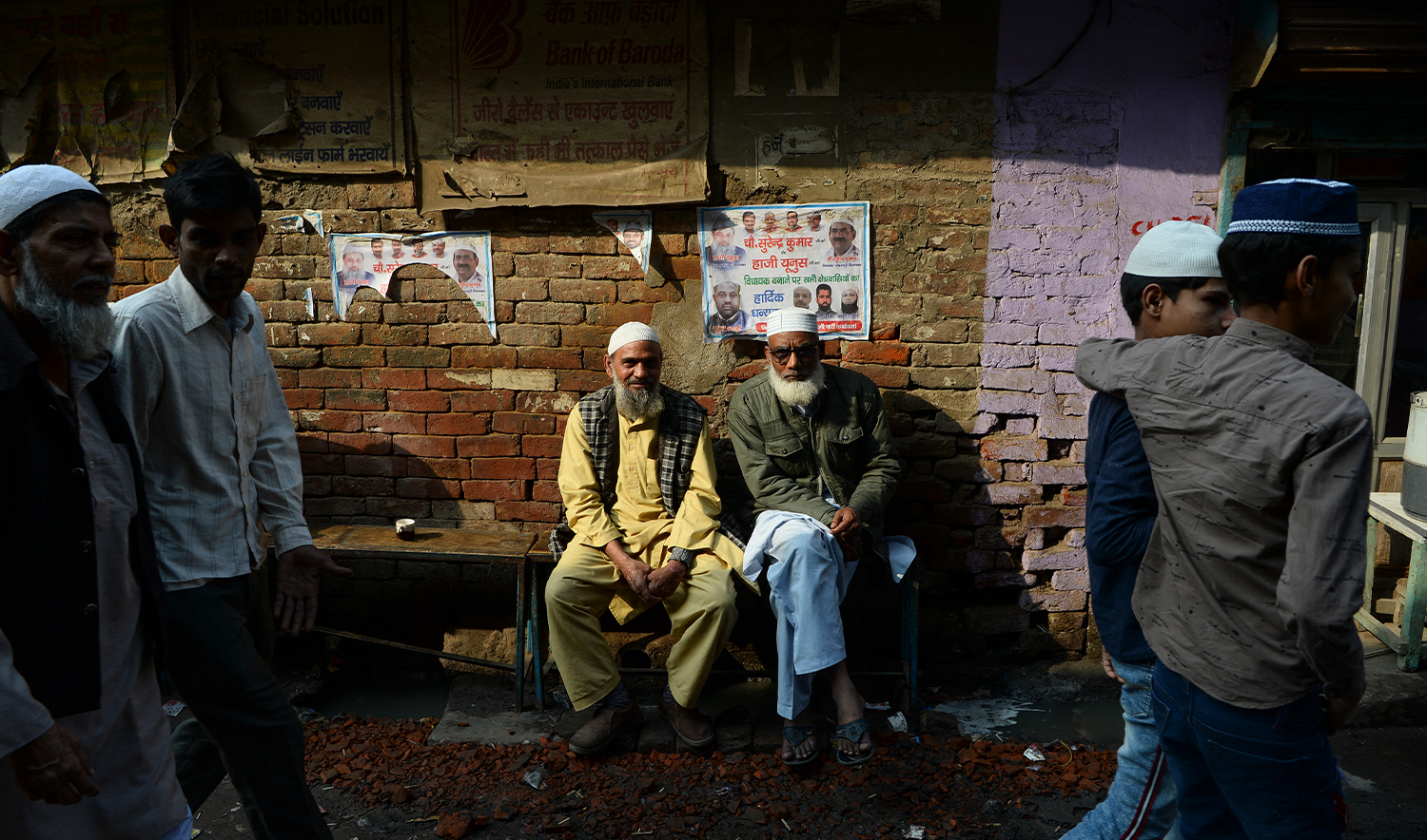 Muslim men sit along a road in a riot-affected area, in New Delhi on March 1, 2020, after violence broke out in India's capital. (AFP/File)