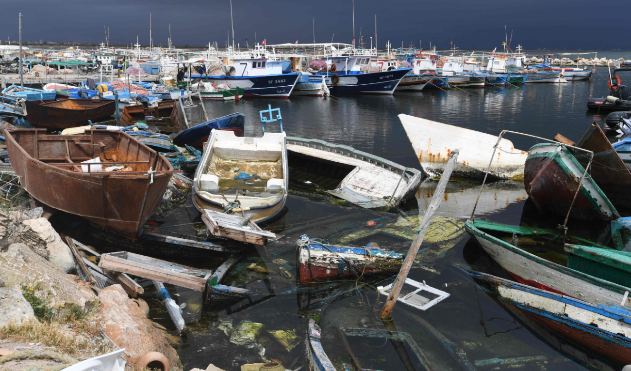 The remains of boats used by migrants to cross the Mediterranean are scattered along the port of El-Amra in Tunisia’s Sfax governorate. (AFP)