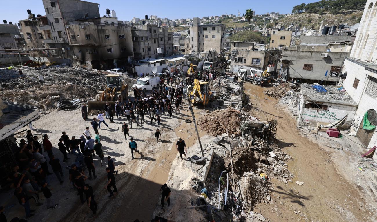 People carry the body of a man during his funeral procession, amid the devastation left behind following an Israeli raid in the Nur Shams camp for Palestinian refugees in the occupied West Bank, on April 21, 2024. (AFP/File)