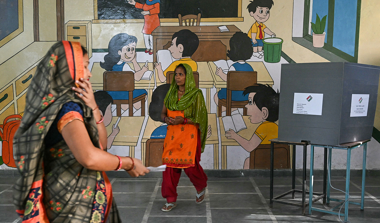 A women voter walks toward the exit after casting her ballot at a polling station in the second phase of India’s general elections in Meerut, in Uttar Pradesh state on April 26, 2024. (AFP)