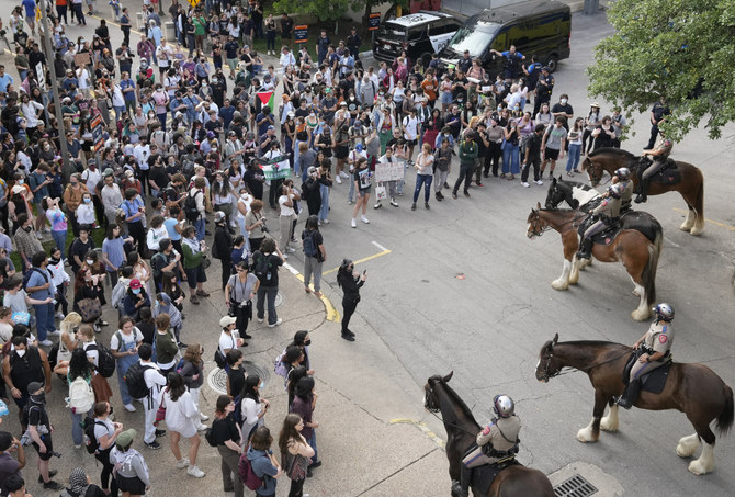 Pro-Palestinian protesters face off with mounted state troopers at the University of Texas on April 24, 2024, in Austin, Texas. (Austin American-Statesman via AP)
