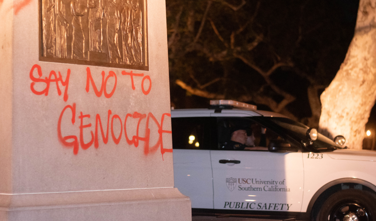 A USC Department of Public Safety vehicle sits next to the base of the Tommy Trojan statue that was tagged in Hahn Plaza at the University of Southern California (USC) in Los Angeles, California, on April 28, 2024. (AFP)
