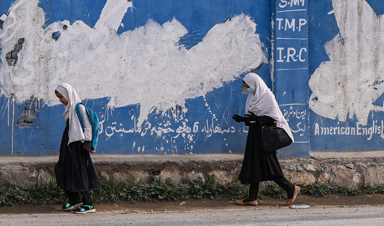 Afghan primary school children walk along a road in Khost on April 22, 2024. (AFP/File)