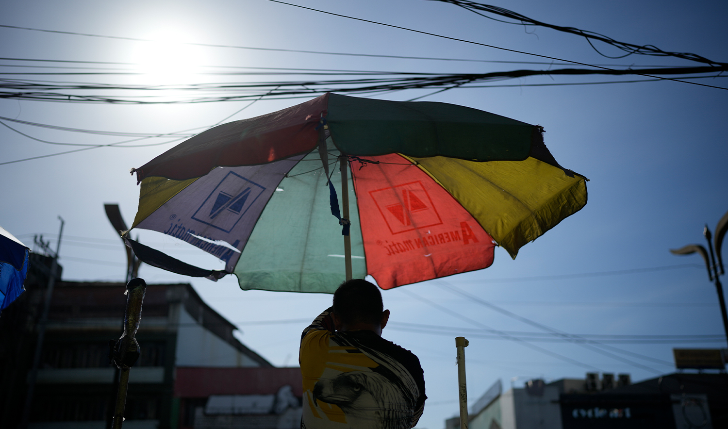 A vendor prepares his umbrella as hot days continue in Manila, Philippines on April 29, 2024. (AP)