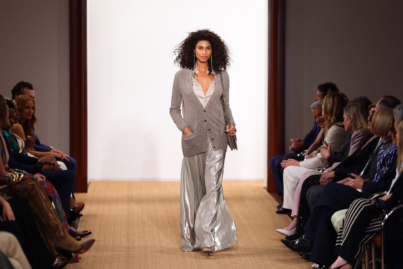 Imaan Hammam graced the catwalk in a button-down silk dress in a metallic cream hue. (AFP)