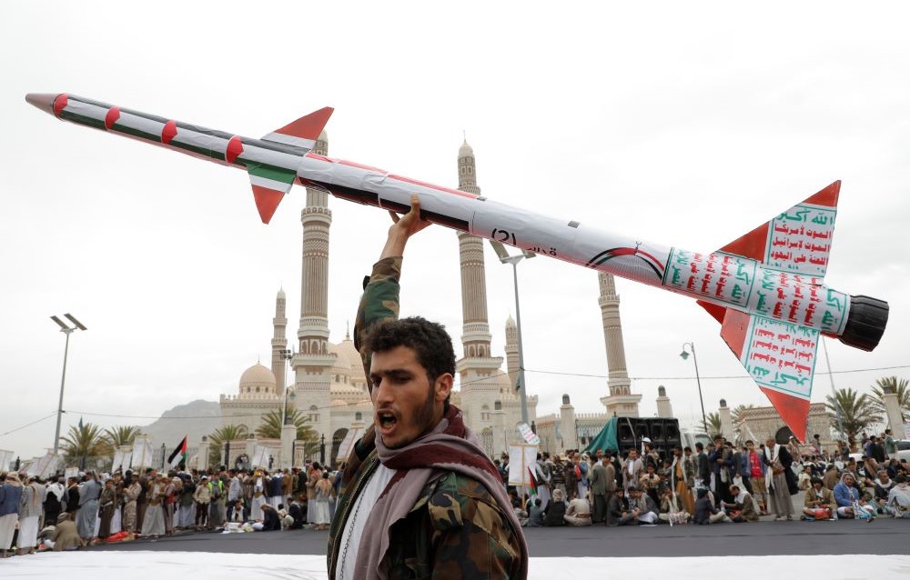 A Houthi supporter raises a mock rocket during a rally against the US and Israel and to support Palestinians in the Gaza Strip, in Sanaa, Yemen, Friday, April. 26, 2024. (AP Photo)