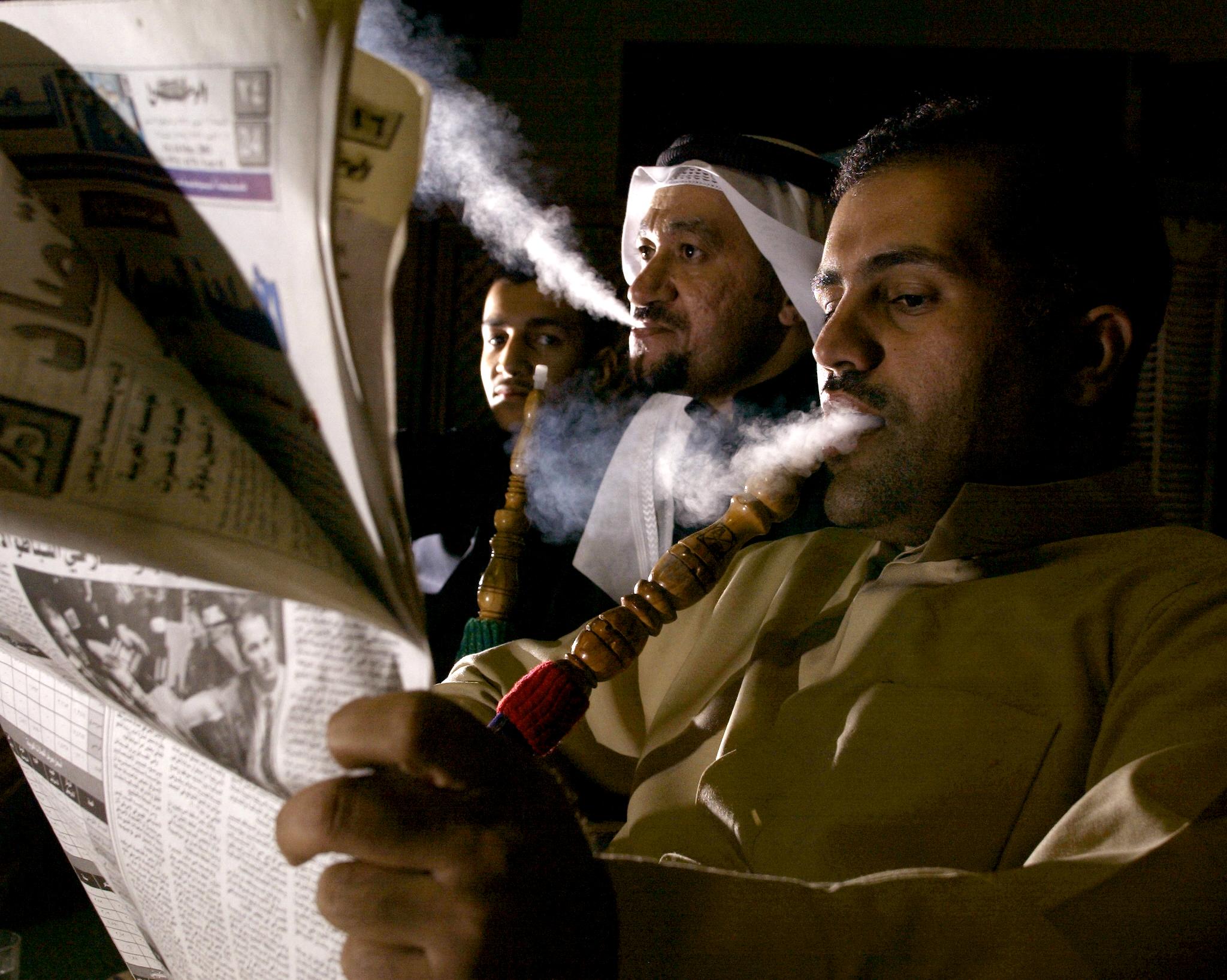 Kuwaitis Abu Mishari (L), Fahad Ghanim(C), and Salah Ghanim(L) have a late night smoke of Shesha. (File/AFP)