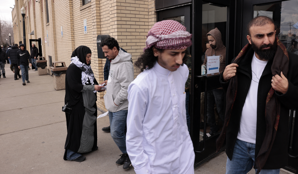 Samra'a Luqman (L) asks voters not to vote for Joe Biden outside the American Moslem Society Mosque in Michigan. (AFP)
