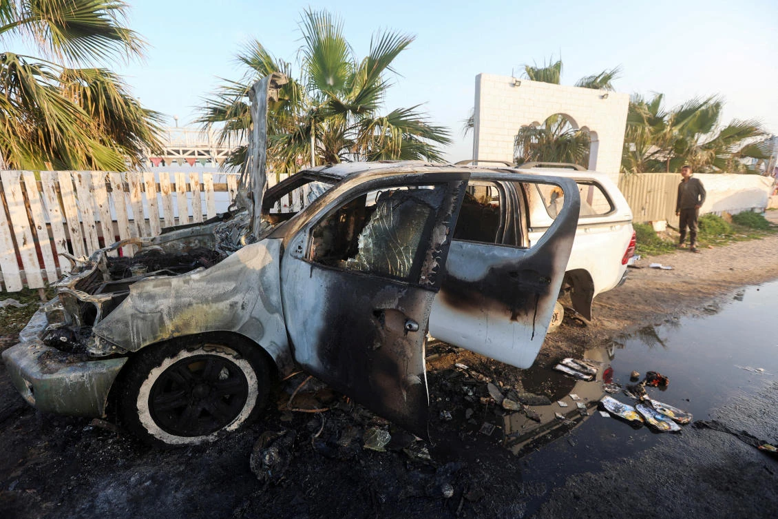 A person looks at a vehicle where employees from the World Central Kitchen were killed in an Israeli airstrike, according to the NGO as the Israeli military said it was conducting a thorough review at the highest levels to understand the circumstances of this “tragic” incident on Apr. 2, 2024. (Reuters)