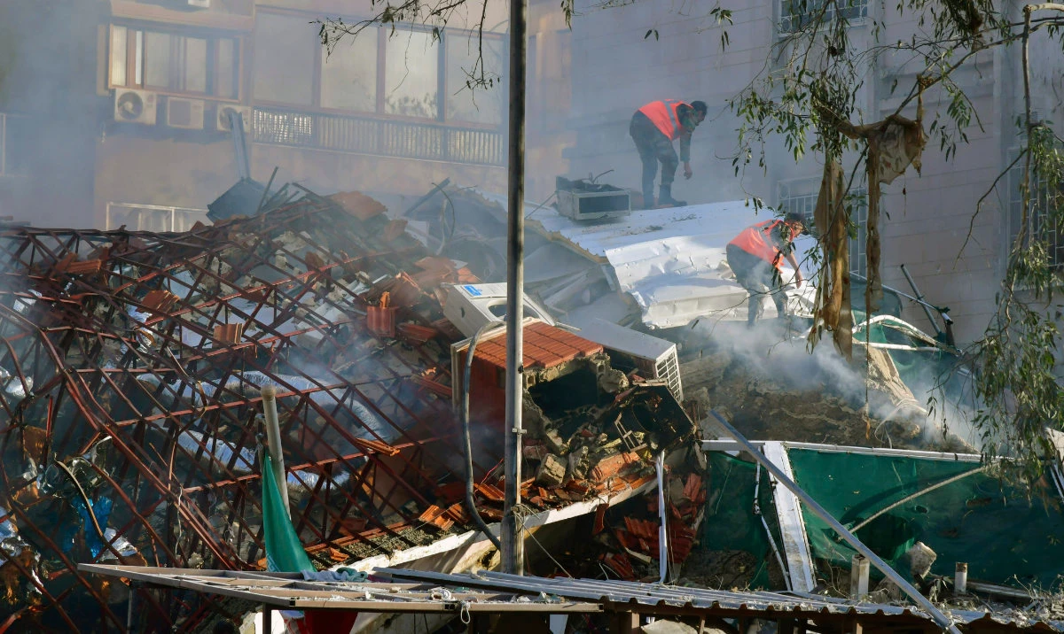 In this photo released by the official Syrian state news agency SANA, emergency service workers clear the rubble at a destroyed building struck by Israeli jets in Damascus, Syria, Monday, April 1, 2024. (AP)