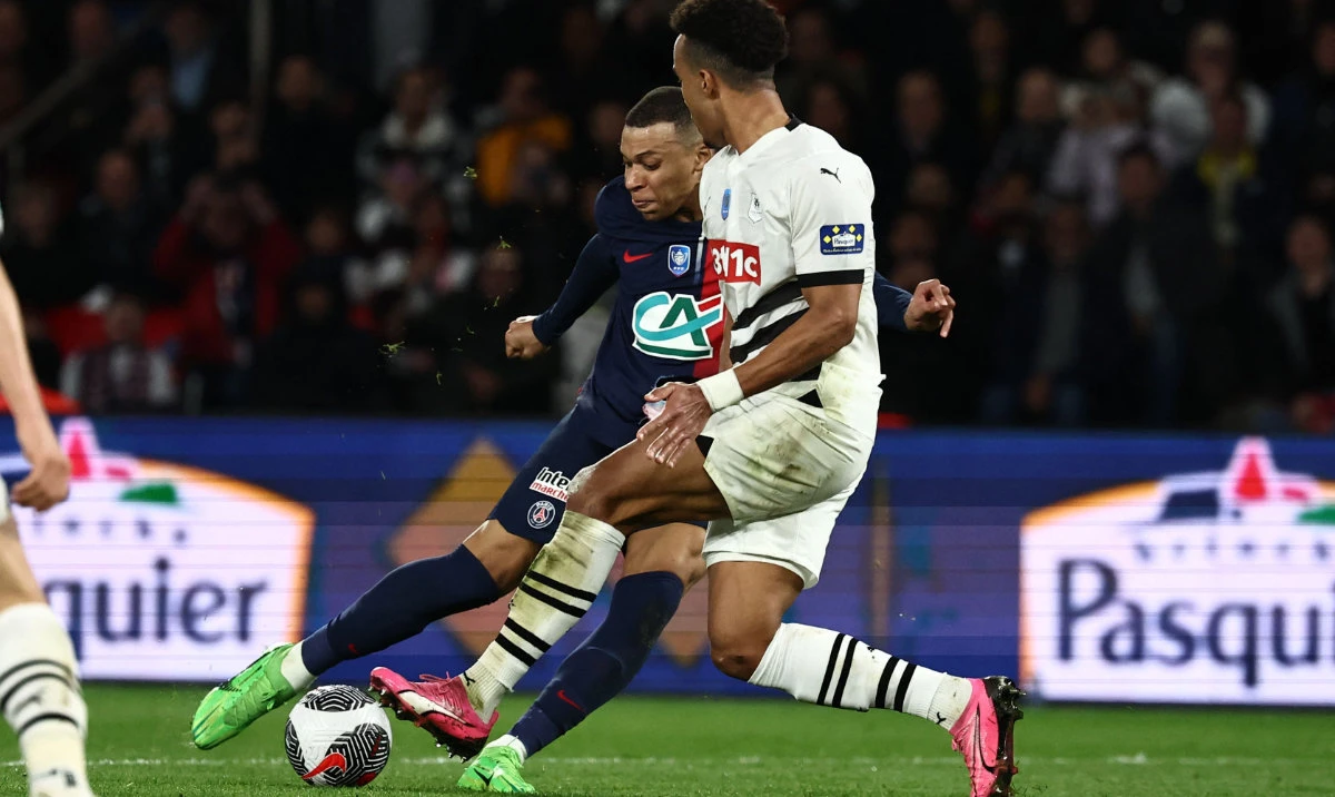 Paris Saint-Germain's French forward Kylian Mbappe kicks the ball and scores his team's goal during the French Cup (Coupe de France) semifinal football match between Paris Saint-Germain (PSG) and Stade Rennais FC at the Parc des Princes stadium in Paris on April 3, 2024. (AFP)