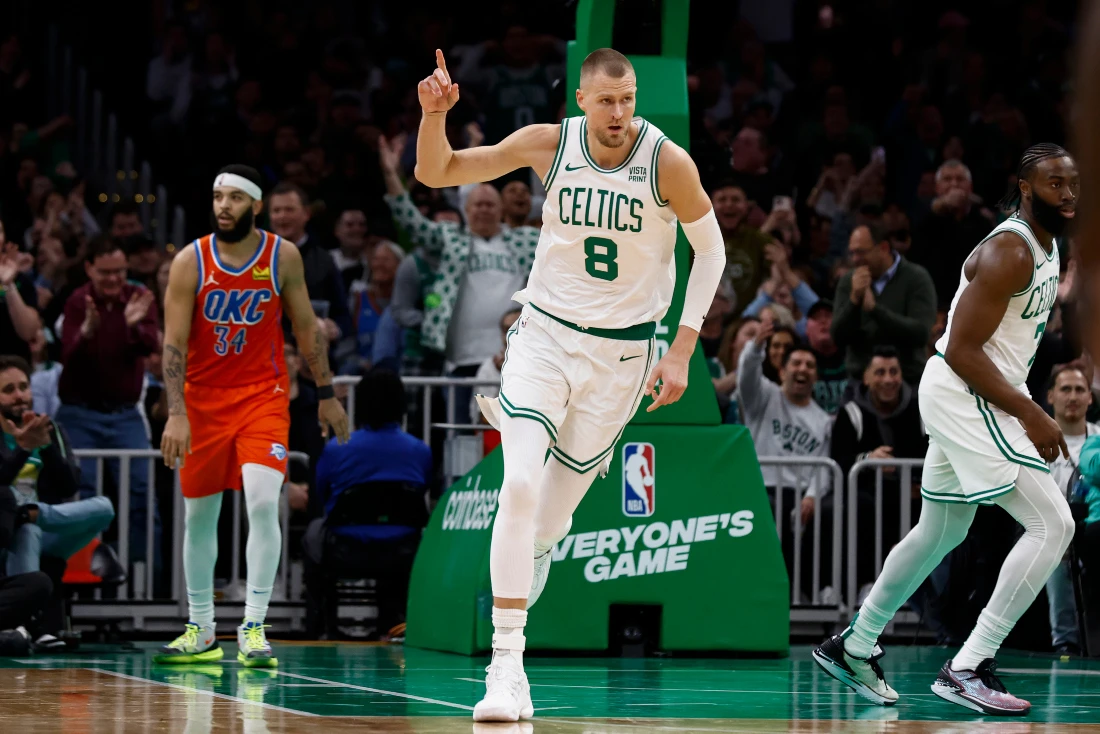 Boston Celtics' Kristaps Porzingis heads back upcourt after making a 3-point basket against the Oklahoma City Thunder during the second half of an NBA basketball game in Boston. (AP)