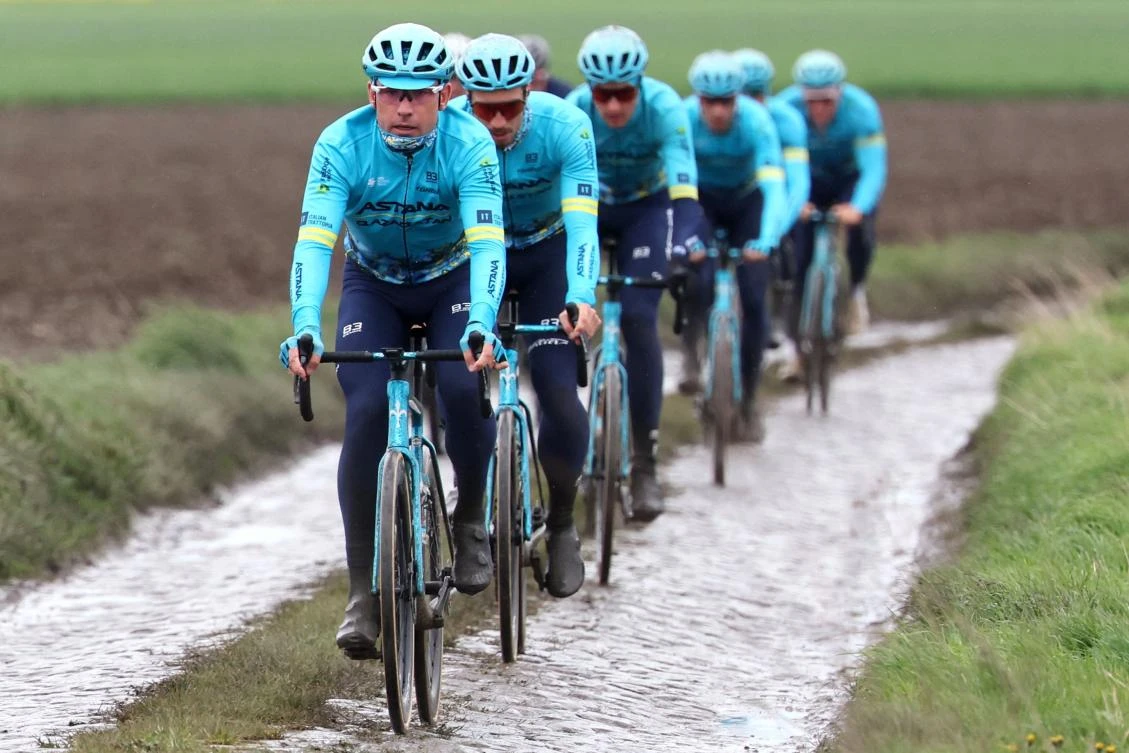 Team Astana Qazaqstan riders cycle on the paved sector during a reconnaissance ride for the 121st edition of the Paris-Roubaix up cycling event in Haveluy on Apr. 5, 2024. (AFP)