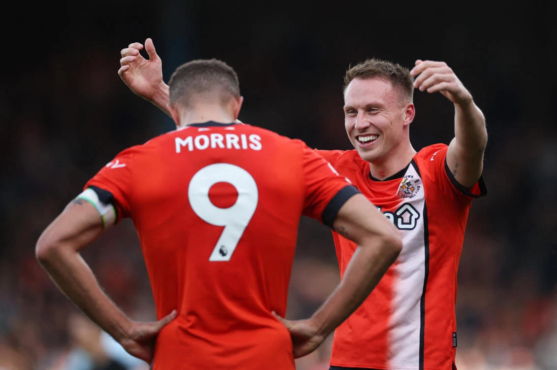 Luton Town’s Cauley Woodrow and Carlton Morris celebrate after their Premier League match against AFC Bournemouth at Kenilworth Road, Luton, on Apr. 6, 2024. (Reuters)