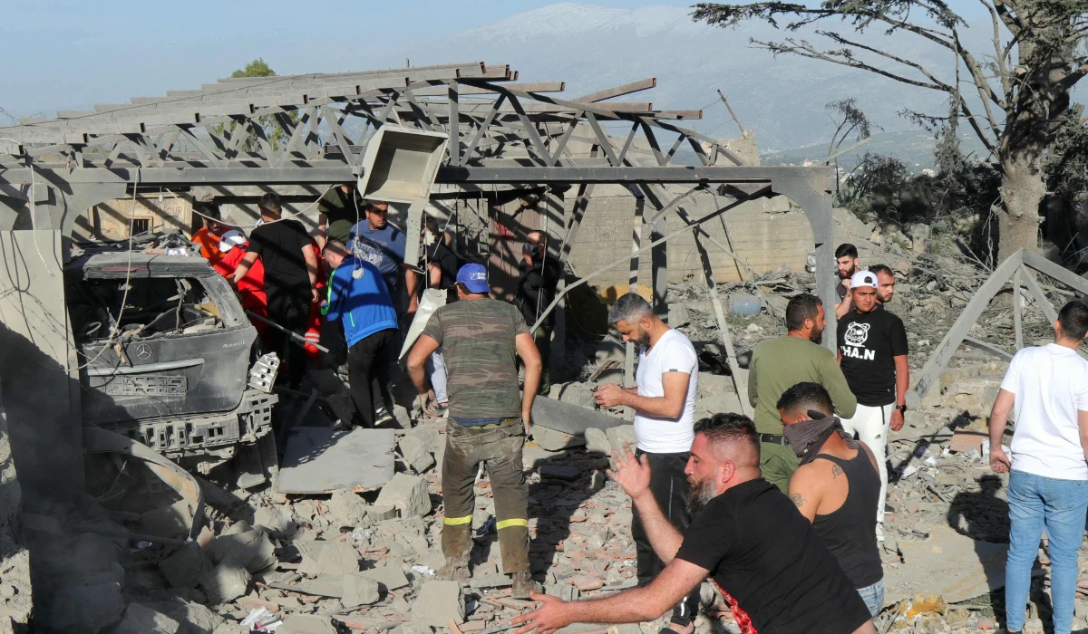 Emergency responders dig through the rubble of a building after an Israeli strike on a house in Lebanese town of Marjayoun on April 5, 2024, during a cross-border exchange between Lebanon and Israel. (AFP)